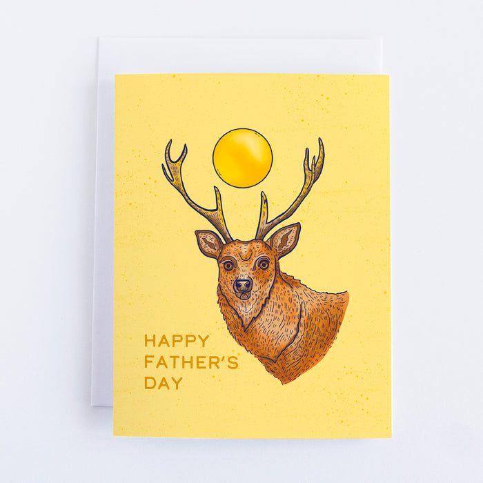 A yellow greeting card with a deer with the sun in the middle of his antlers. The text says happy fathers day.