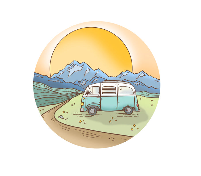A circle sticker with a mountain landscape with a vintage blue van in the foreground parked next to a winding dirt road and it is parked in a green field.