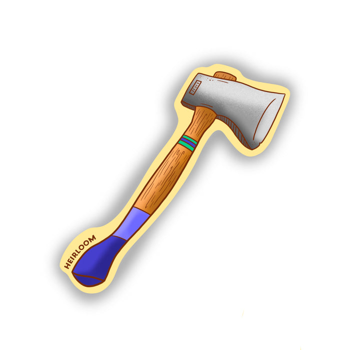 A vintage-looking ax with a wooden handle that has blue stripes painted on the wooden handle. IT is on a light yellow background.