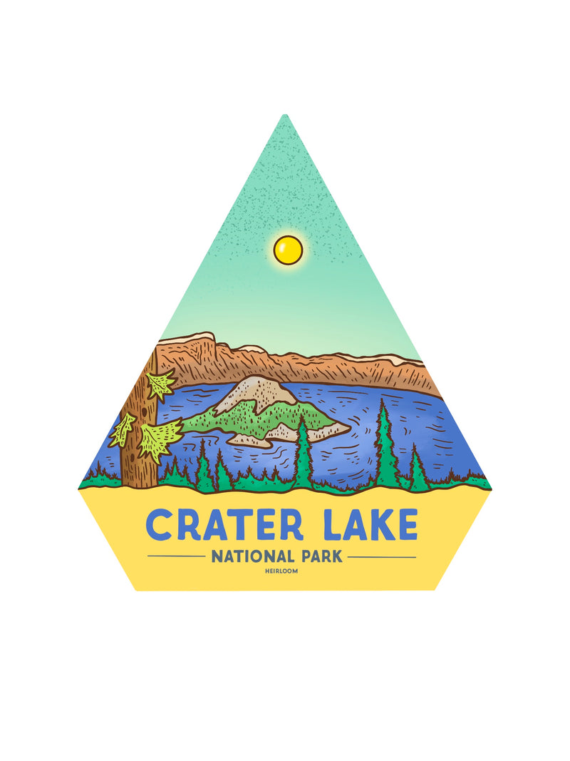 A diamond shaped sticker with a blue lake and island in the middle and trees in the foreground. The text says Crater Lake National Park.