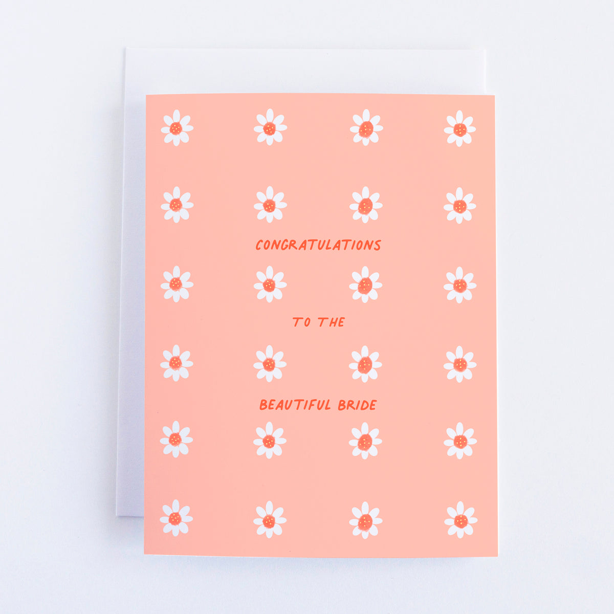 A pink greeting card with little white flowers with dark pink centers in 6 rows of 4 flowers. The text reads "Congratulations to the Beautiful Bride".