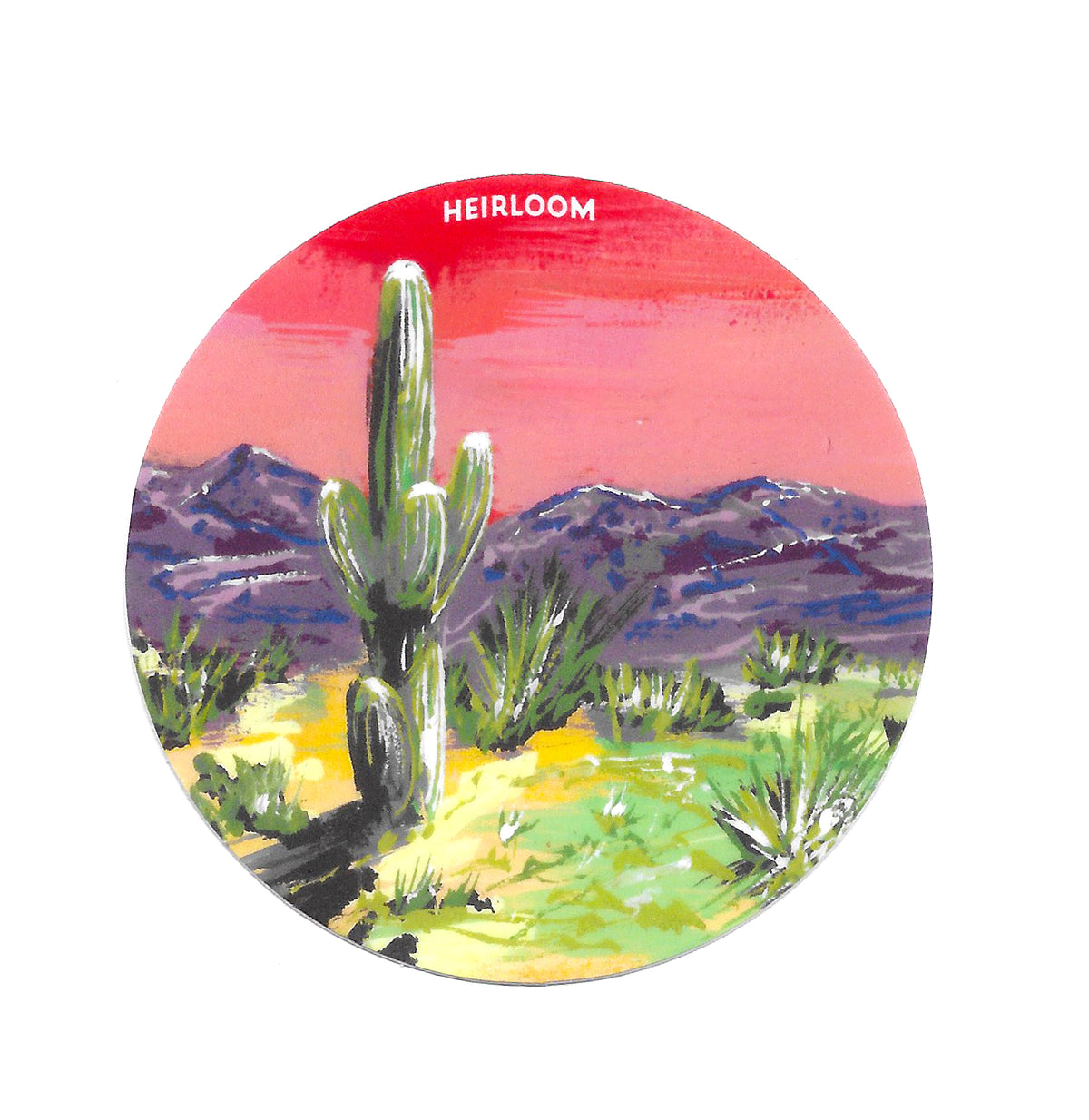A circle sticker with a pink background and purple mountains with a sand and cactus in the foreground and a large saguaro taking up most of the space as the focus.