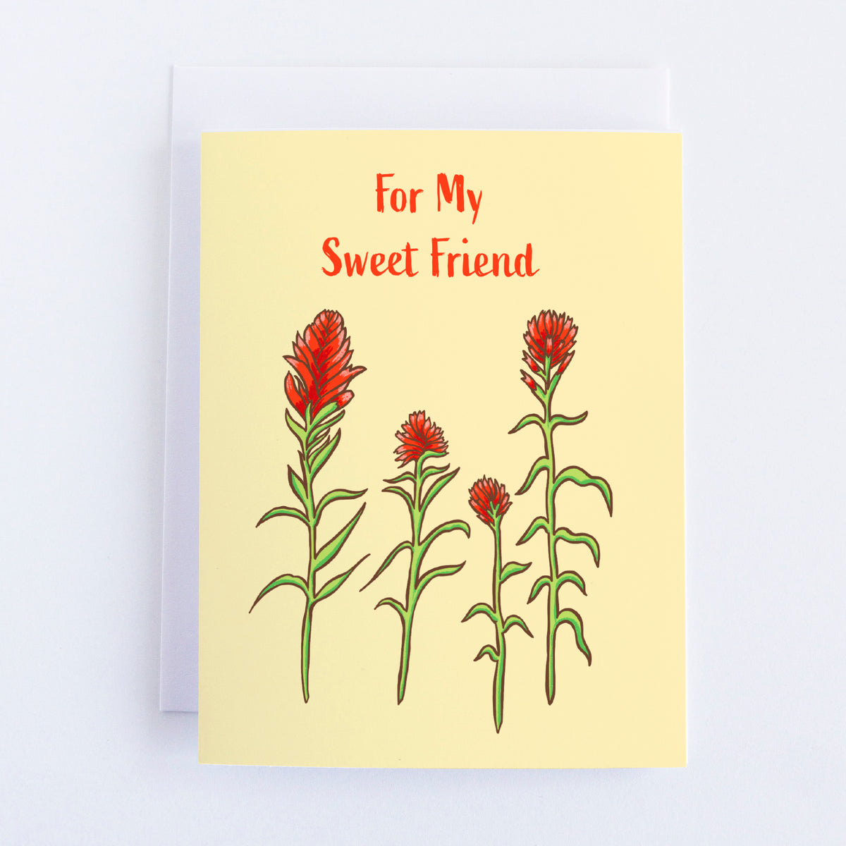A light yellow card with four red paintbrush wildflower stems painted on the front. The text above it reads For My Sweet Friend.