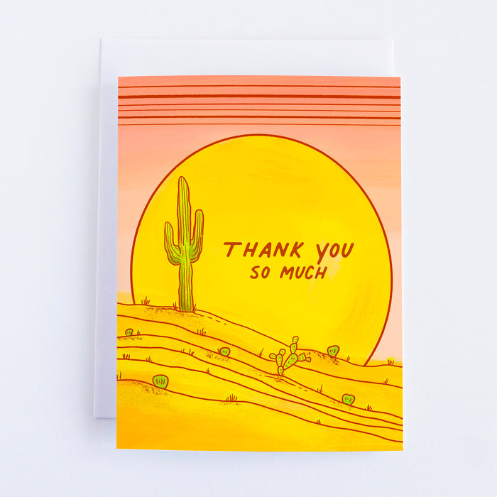 A greeting card with a pink background and a yellow sun with a saguaro cactus in front and desert with other cactus and inside the sun the text says Thank You So Much.
